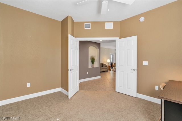 unfurnished office featuring ceiling fan and carpet flooring