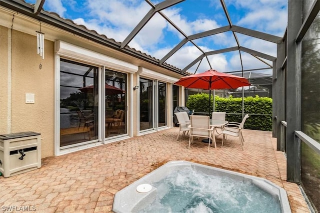 view of patio / terrace with outdoor dining area and an outdoor hot tub