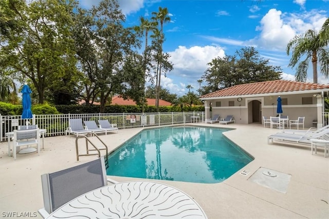 community pool featuring a patio area and fence