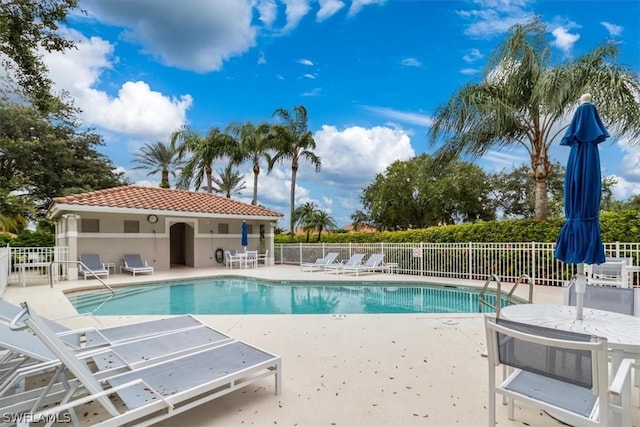 community pool featuring a patio and fence