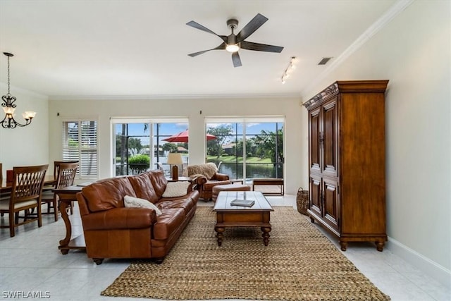 living area featuring a healthy amount of sunlight, baseboards, visible vents, and crown molding