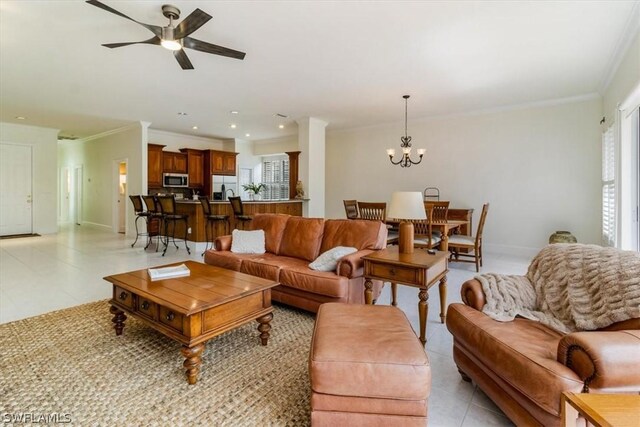 living area with light tile patterned floors, baseboards, ceiling fan with notable chandelier, crown molding, and recessed lighting