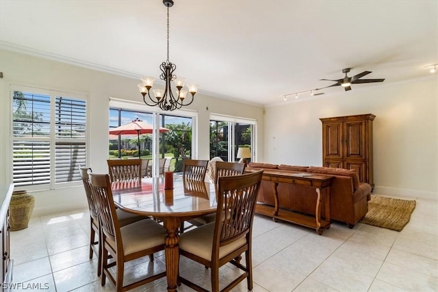 dining space with baseboards, light tile patterned floors, ceiling fan with notable chandelier, and crown molding