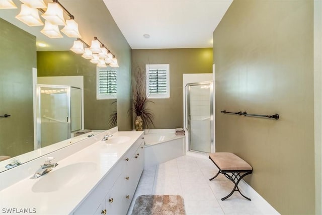 full bathroom with tile patterned flooring, double vanity, a stall shower, and a sink