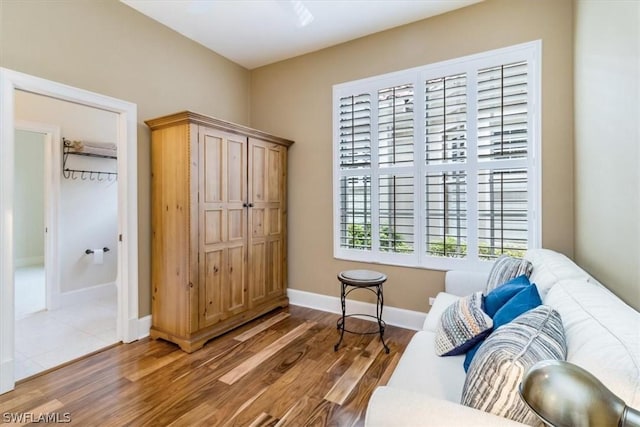 living area featuring baseboards and wood finished floors