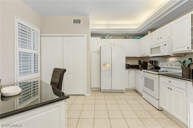 kitchen featuring white cabinetry, light tile patterned floors, and white appliances