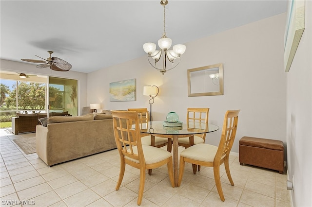 dining room with light tile patterned flooring and ceiling fan with notable chandelier