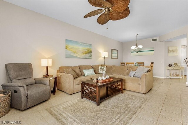 living room featuring ceiling fan with notable chandelier and light tile patterned floors