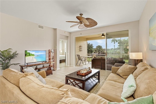 living room with ceiling fan and light tile patterned flooring