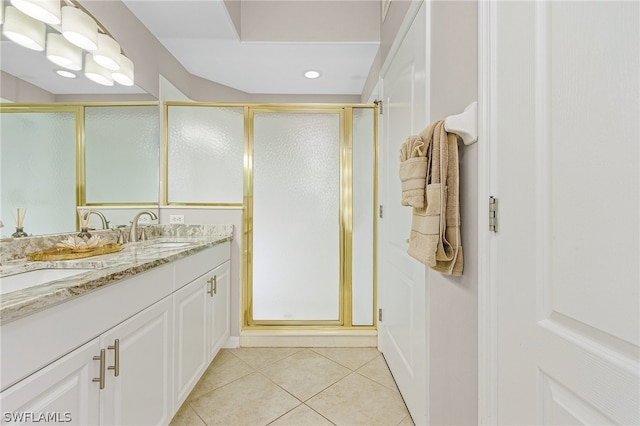 bathroom featuring walk in shower, tile patterned floors, and double sink vanity