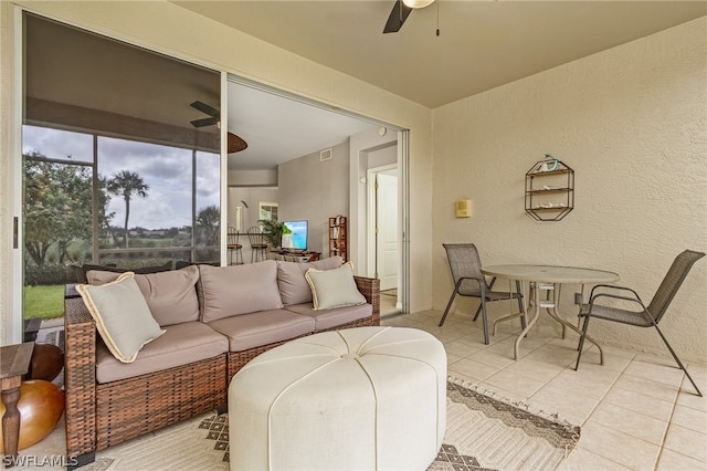 tiled living room featuring ceiling fan