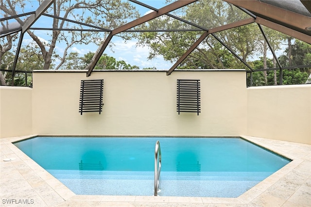 view of swimming pool with a patio and glass enclosure