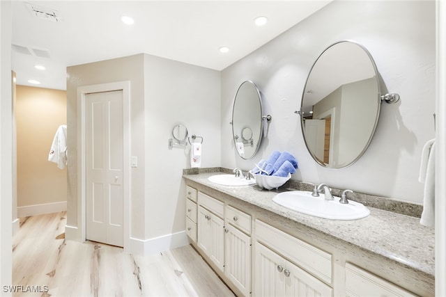 bathroom with vanity and wood-type flooring