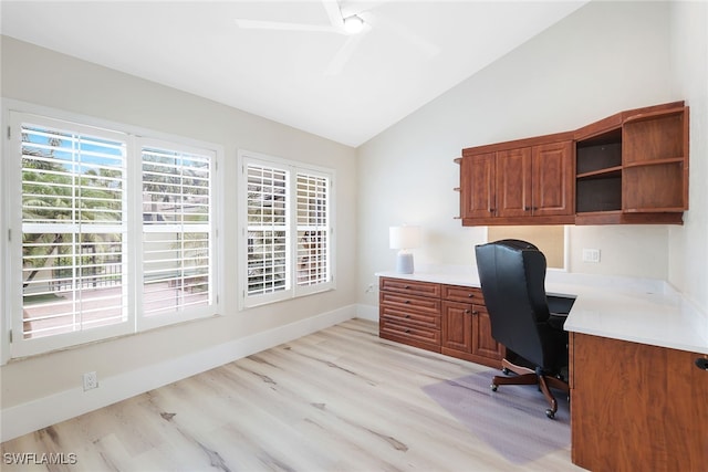 office space featuring light hardwood / wood-style flooring, lofted ceiling, built in desk, and ceiling fan