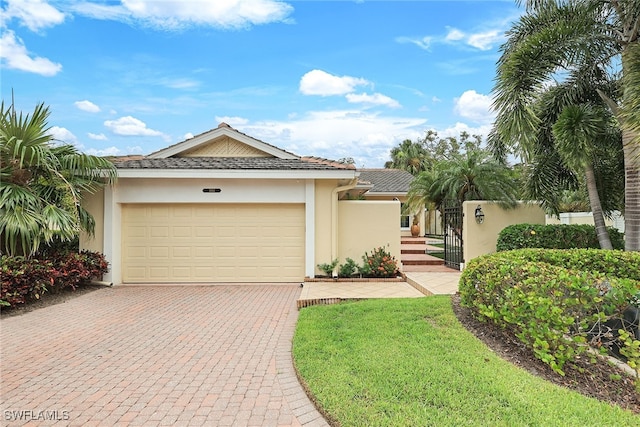 view of front of home with a garage and a front lawn