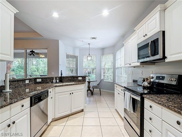 kitchen with sink, stainless steel appliances, and white cabinets