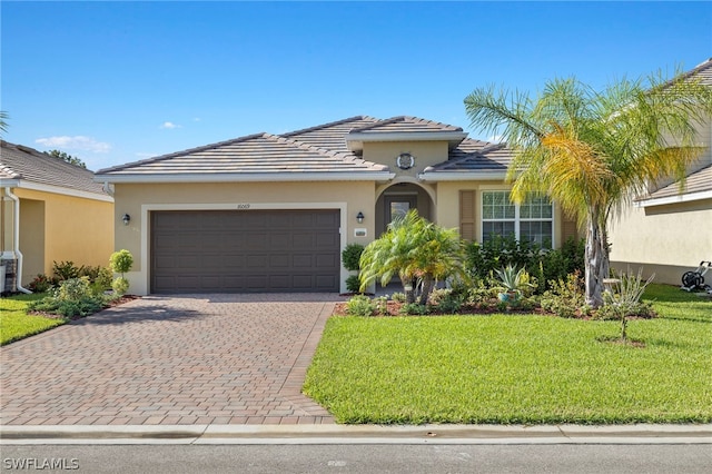 view of front of house featuring a garage and a front lawn