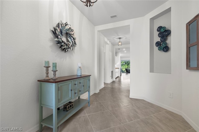 hall featuring light tile patterned flooring