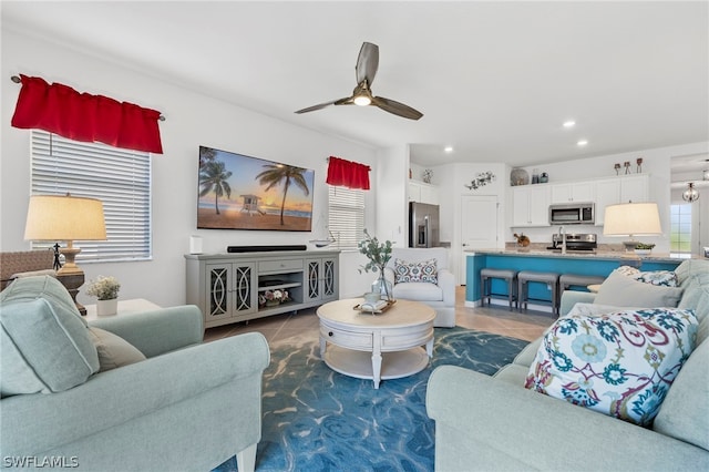 tiled living room with ceiling fan