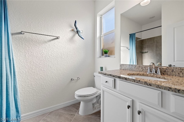 bathroom with tile patterned floors, vanity, and toilet