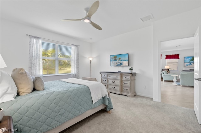 bedroom featuring ceiling fan and light carpet