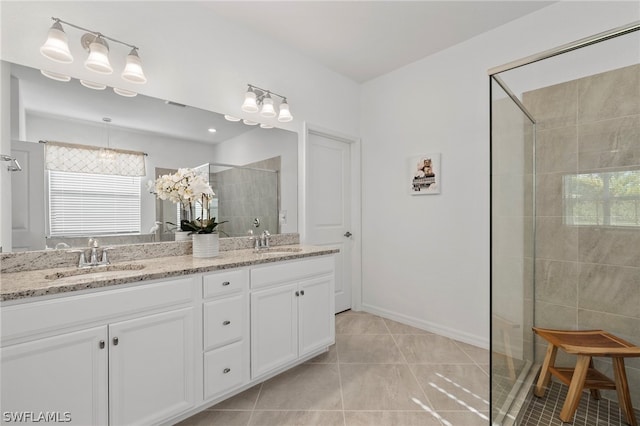 bathroom featuring tile patterned flooring, vanity, and a shower with shower door