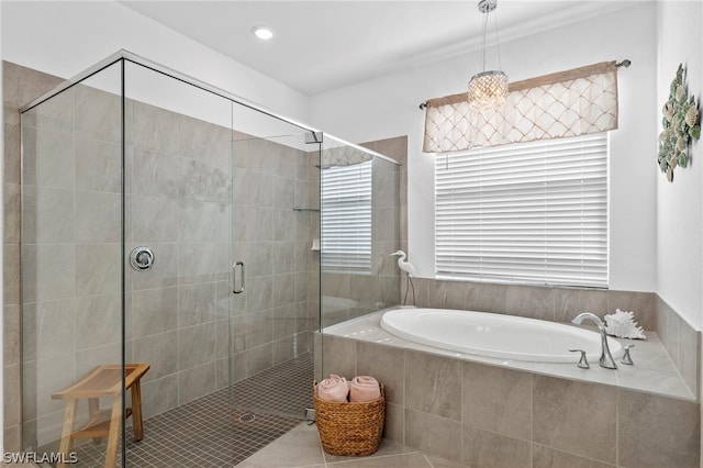 bathroom featuring separate shower and tub