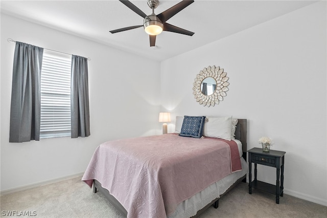 bedroom featuring ceiling fan and light colored carpet