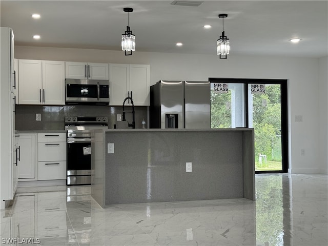 kitchen with light tile patterned floors, an inviting chandelier, white cabinets, stainless steel appliances, and pendant lighting