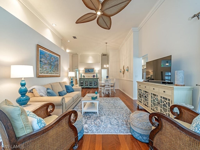 living room featuring hardwood / wood-style floors, ceiling fan, and crown molding