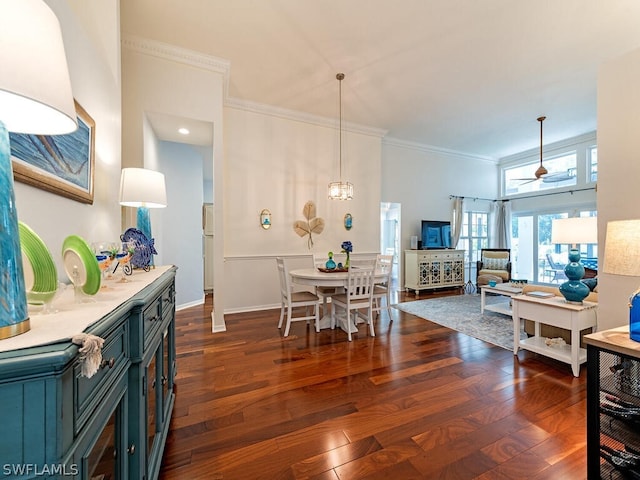 dining room with ceiling fan, dark hardwood / wood-style flooring, and ornamental molding