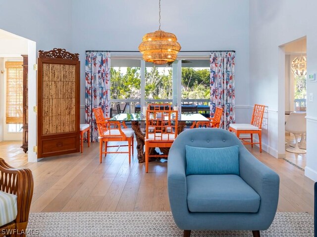 dining area featuring wood-type flooring and a chandelier