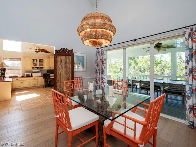 dining area with light wood-type flooring, ceiling fan, and built in desk