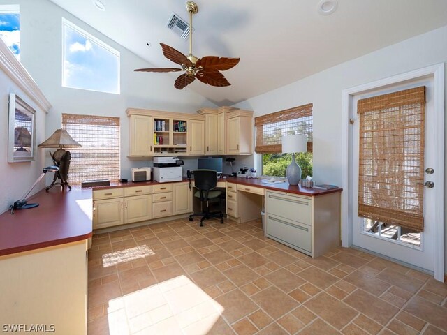 home office featuring ceiling fan, a wealth of natural light, and built in desk