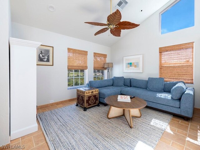 tiled living room with high vaulted ceiling and ceiling fan