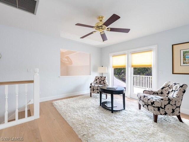 living area with light hardwood / wood-style flooring and ceiling fan