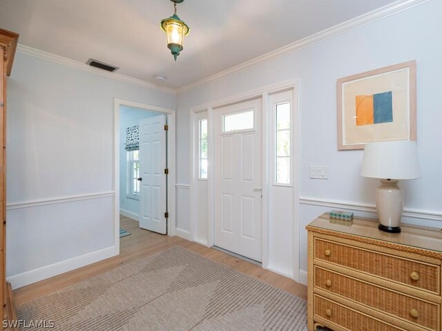 entrance foyer with light wood-type flooring and ornamental molding