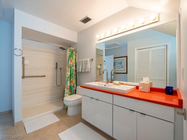 bathroom with vanity, toilet, curtained shower, and tile patterned floors