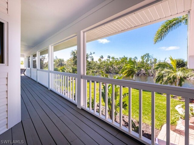 deck featuring a water view and a yard