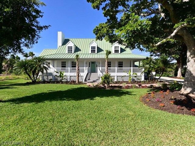 view of front of home featuring a front yard and a porch