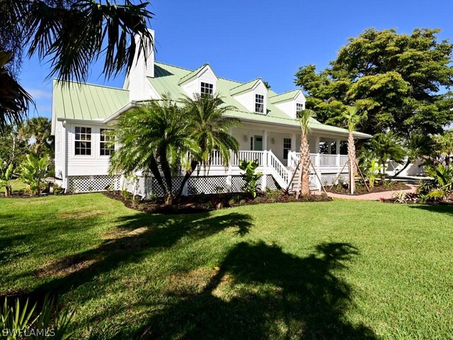 exterior space with covered porch and a front lawn