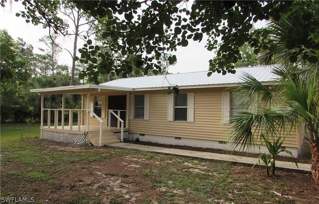 440 14th Ave NE, Naples, FL 34120 - view of front facade with crawl space and metal roof