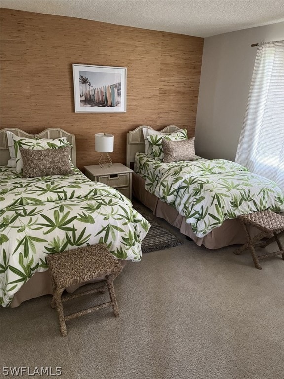 carpeted bedroom featuring wooden walls and a textured ceiling