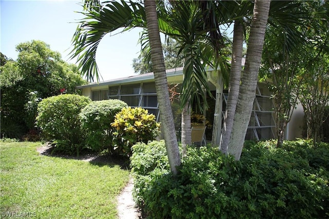 view of home's exterior with a yard