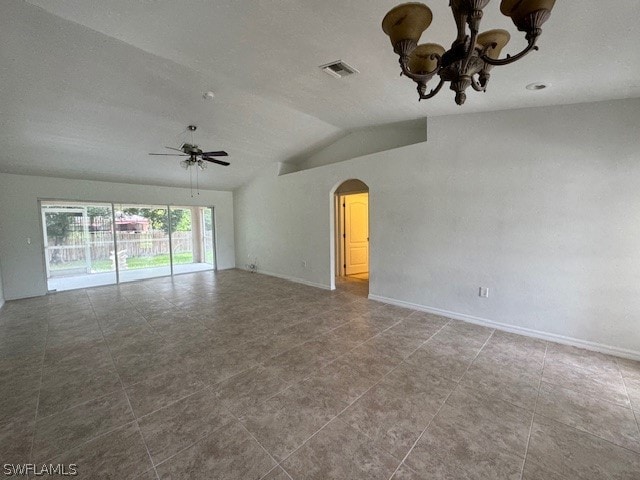 tiled spare room with ceiling fan with notable chandelier and vaulted ceiling