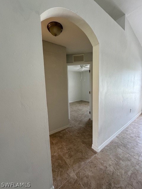 hall with tile patterned floors