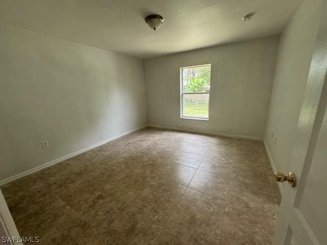 2813 52nd St W, Lehigh Acres, FL 33971 - empty room with baseboards and tile patterned floors