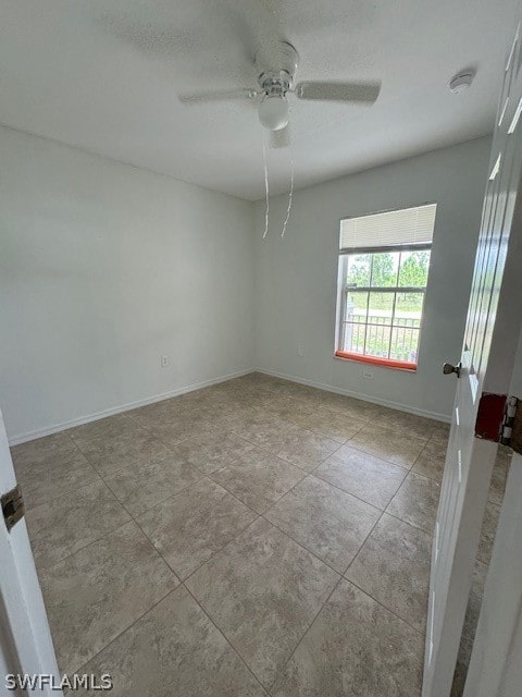 unfurnished room with light tile patterned floors and ceiling fan