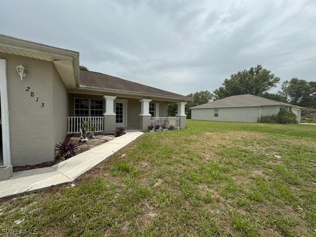 2813 52nd St W, Lehigh Acres, FL 33971 - view of grassy yard featuring covered porch