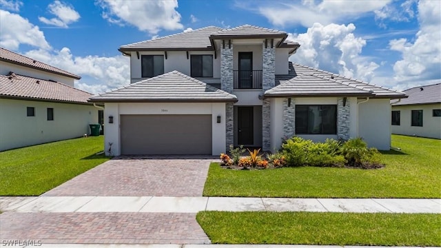 prairie-style home featuring a garage and a front lawn